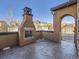 Outdoor living space with a cozy fireplace and decorative privacy screen at 2256 S Isabell Ct, Lakewood, CO 80228