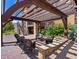 Inviting backyard patio with stone surround, pergola, and comfortable seating perfect for outdoor entertaining at 2256 S Isabell Ct, Lakewood, CO 80228