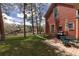 Backyard deck features outdoor seating and grill with views of mature trees and scenic mountain backdrop at 102 S High St, Breckenridge, CO 80424
