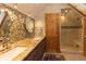 Bathroom featuring a double sink, walk-in shower with a wooden door at 102 S High St, Breckenridge, CO 80424