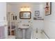 Bright bathroom with pedestal sink, bathtub, and decorative accents at 102 S High St, Breckenridge, CO 80424