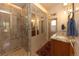 Bright bathroom featuring a walk-in shower, granite countertops, and ample storage at 102 S High St, Breckenridge, CO 80424