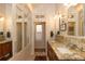 Bright bathroom featuring granite countertops, double sinks, and ample storage at 102 S High St, Breckenridge, CO 80424