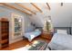 Bright bedroom featuring wood floors, two twin beds, and lots of natural light at 102 S High St, Breckenridge, CO 80424
