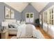 This bedroom features neutral colors, a large window, and doors that lead outside at 102 S High St, Breckenridge, CO 80424