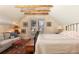 Comfortable bedroom with decorative wallpaper, wooden beams, and lots of natural light at 102 S High St, Breckenridge, CO 80424
