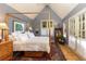 Bedroom with wooden-framed four-poster bed, hardwood floor, and french doors to the outside at 102 S High St, Breckenridge, CO 80424