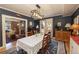 Formal dining room featuring blue textured wallpaper, wood floors, and modern light fixture at 102 S High St, Breckenridge, CO 80424