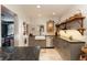 Modern kitchen with gray cabinets, stainless steel appliances, granite countertops, and open shelving at 102 S High St, Breckenridge, CO 80424