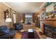 Cozy living room with fireplace, vintage furniture, and light-colored walls and hard wood floors at 102 S High St, Breckenridge, CO 80424