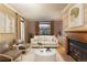 Cozy living room with a fireplace, neutral tones, and a scenic view from the window at 102 S High St, Breckenridge, CO 80424