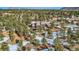 This is an aerial view of home, with a brown roof, nestled amongst the pine trees in a snowy forest setting at 1298 Silverheels Dr, Larkspur, CO 80118