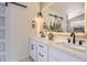 Modern bathroom features double sinks, white countertops, dark hardware, and a sliding barn door at 1298 Silverheels Dr, Larkspur, CO 80118