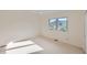 Minimalist bedroom with carpet flooring, a large window, and natural light at 1298 Silverheels Dr, Larkspur, CO 80118