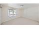 Simple bedroom with carpet floors, a large window, and natural light at 1298 Silverheels Dr, Larkspur, CO 80118