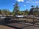 This spacious deck overlooks a serene wooded landscape with winter snow at 1298 Silverheels Dr, Larkspur, CO 80118