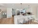 Modern kitchen featuring white cabinets, stainless steel appliances, quartz counters, and breakfast bar seating at 1298 Silverheels Dr, Larkspur, CO 80118