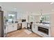 Bright kitchen with white cabinetry, stainless steel appliances, quartz countertops, and modern pendant lighting at 1298 Silverheels Dr, Larkspur, CO 80118