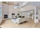 Bright living room boasting a stone fireplace, wood floors, and high vaulted ceilings with a modern chandelier at 1298 Silverheels Dr, Larkspur, CO 80118