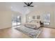 Serene main bedroom with vaulted ceiling, wood floors, access to a private deck, and scenic views at 1298 Silverheels Dr, Larkspur, CO 80118