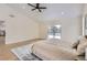 Spacious main bedroom with vaulted ceiling, light-filled windows, wood floors, and a cozy bed setup at 1298 Silverheels Dr, Larkspur, CO 80118