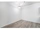 Bright, empty room with hardwood floors and modern lighting fixture, ready for customization at 452 Black Feather Loop # 606, Castle Rock, CO 80104