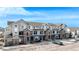Exterior of a complex featuring stone accents, garages, sidewalks and street parking at 452 Black Feather Loop # 606, Castle Rock, CO 80104