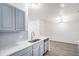 Bright kitchen features modern appliances, gray cabinets, stylish backsplash and eat in nook at 452 Black Feather Loop # 606, Castle Rock, CO 80104