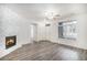 Cozy living room showcases a modern fireplace, hardwood floors, and an open-concept layout with combined dining area at 452 Black Feather Loop # 606, Castle Rock, CO 80104