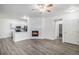 Open-concept living space with a decorative fireplace and ceiling fan at 452 Black Feather Loop # 606, Castle Rock, CO 80104