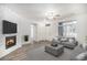 Bright living room features a brick fireplace, wood floors, and lots of natural light from large windows at 452 Black Feather Loop # 606, Castle Rock, CO 80104