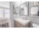 Well-lit bathroom vanity with sink, wood cabinets and a view into bedroom at 1128 S Ventura Cir # B, Aurora, CO 80017