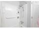 Clean bathroom featuring a white shower with shelving and shower head at 1128 S Ventura Cir # B, Aurora, CO 80017