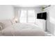 Bright bedroom with neutral tones, queen bed, large window, with natural light at 1128 S Ventura Cir # B, Aurora, CO 80017