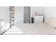 Neutral bedroom with a queen bed, closet, and view into the bathroom at 1128 S Ventura Cir # B, Aurora, CO 80017