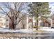 A beautiful, two-story condo with wood stairs, covered balconies, and a snowy yard at 1128 S Ventura Cir # B, Aurora, CO 80017
