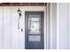 Close-up of a black door with a transom window, light fixture, and unit number at 1128 S Ventura Cir # B, Aurora, CO 80017