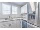 Well-lit kitchen featuring stainless steel appliances, ample counter space, and modern white cabinets at 1128 S Ventura Cir # B, Aurora, CO 80017