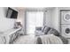 Comfortable living room featuring a sofa, desk, TV, and sliding glass doors at 1128 S Ventura Cir # B, Aurora, CO 80017