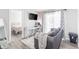 Cozy living room with a sofa, work desk, TV, and bedroom doorway at 1128 S Ventura Cir # B, Aurora, CO 80017