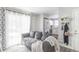 Relaxing living room with a view of the stacked laundry, kitchen and hallway at 1128 S Ventura Cir # B, Aurora, CO 80017
