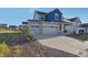 Two-story house with gray siding and a two-car garage at 1123 Williams Loop, Elizabeth, CO 80107