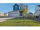 Two-story house with gray and blue siding and a front porch at 1123 Williams Loop, Elizabeth, CO 80107