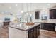 Open concept kitchen with island and views into living room at 1123 Williams Loop, Elizabeth, CO 80107