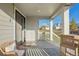 Covered porch with seating area and sliding glass door at 1123 Williams Loop, Elizabeth, CO 80107