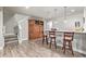 Basement bar area features sleek countertops, pendant lighting, a built-in cabinet, and barstool seating at 11884 Barrentine Loop, Parker, CO 80138