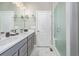 This bathroom has a double vanity with marble countertop and a glass enclosed shower at 11884 Barrentine Loop, Parker, CO 80138