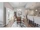 Bright dining room boasts a stylish chandelier, sliding glass door, and an open concept design to the kitchen at 11884 Barrentine Loop, Parker, CO 80138