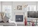 Fireplace detail: White tile, wooden mantle, and white shutters at 11884 Barrentine Loop, Parker, CO 80138