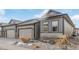 Home exterior showcasing meticulous landscaping, gray color scheme, and a spacious driveway at 11884 Barrentine Loop, Parker, CO 80138